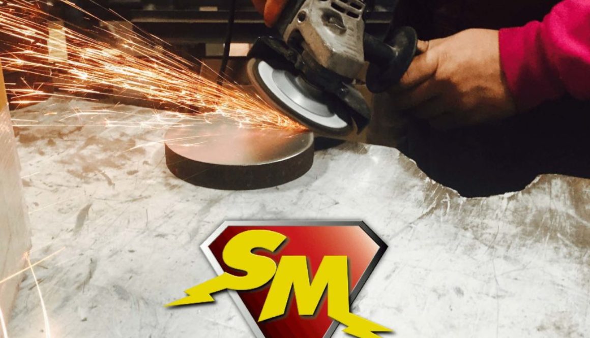 Hands holding a saw cutting a round piece of metal with sparks flying. Below is the Speedy Metals logo, a yellow capital S and capital M on a red, diamond background with the words Speedy Metals below.